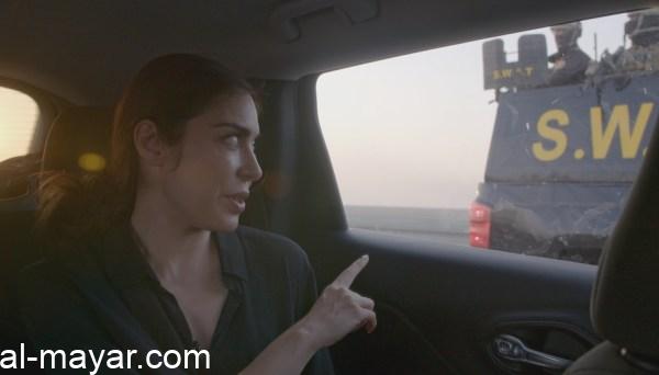 Filmmaker Ramita Navai points to a police escort in a scene from the documentary "Iraq's Assassins." 